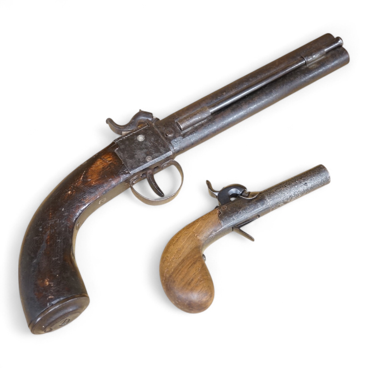 A boxlock percussion pocket pistol with Damascus twist turn off barrel, liege proofs, rounded wooden grip replaced, together with an ‘over and under’ boxlock percussion pistol